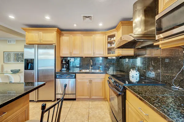 a kitchen with a stove a refrigerator and cabinets