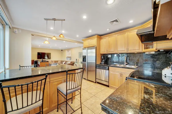 a kitchen with stainless steel appliances kitchen island granite countertop a sink and cabinets
