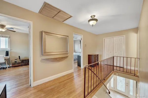 a view of a hallway with wooden floor and staircase
