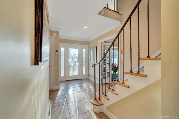 a view of entryway with wooden floor and stairs