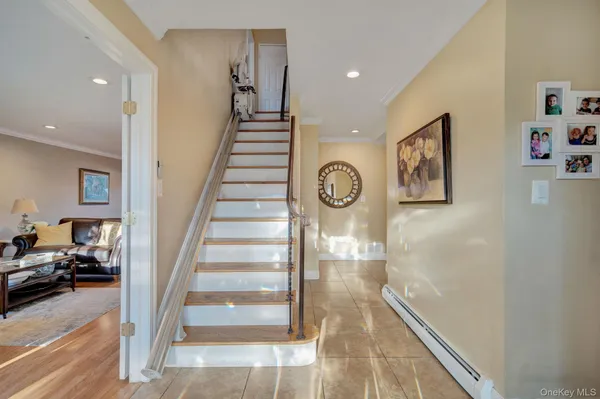 a view of a livingroom with wooden floor and stairs
