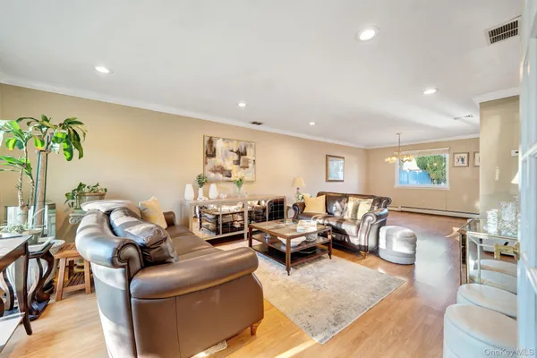 a living room with furniture and a potted plant