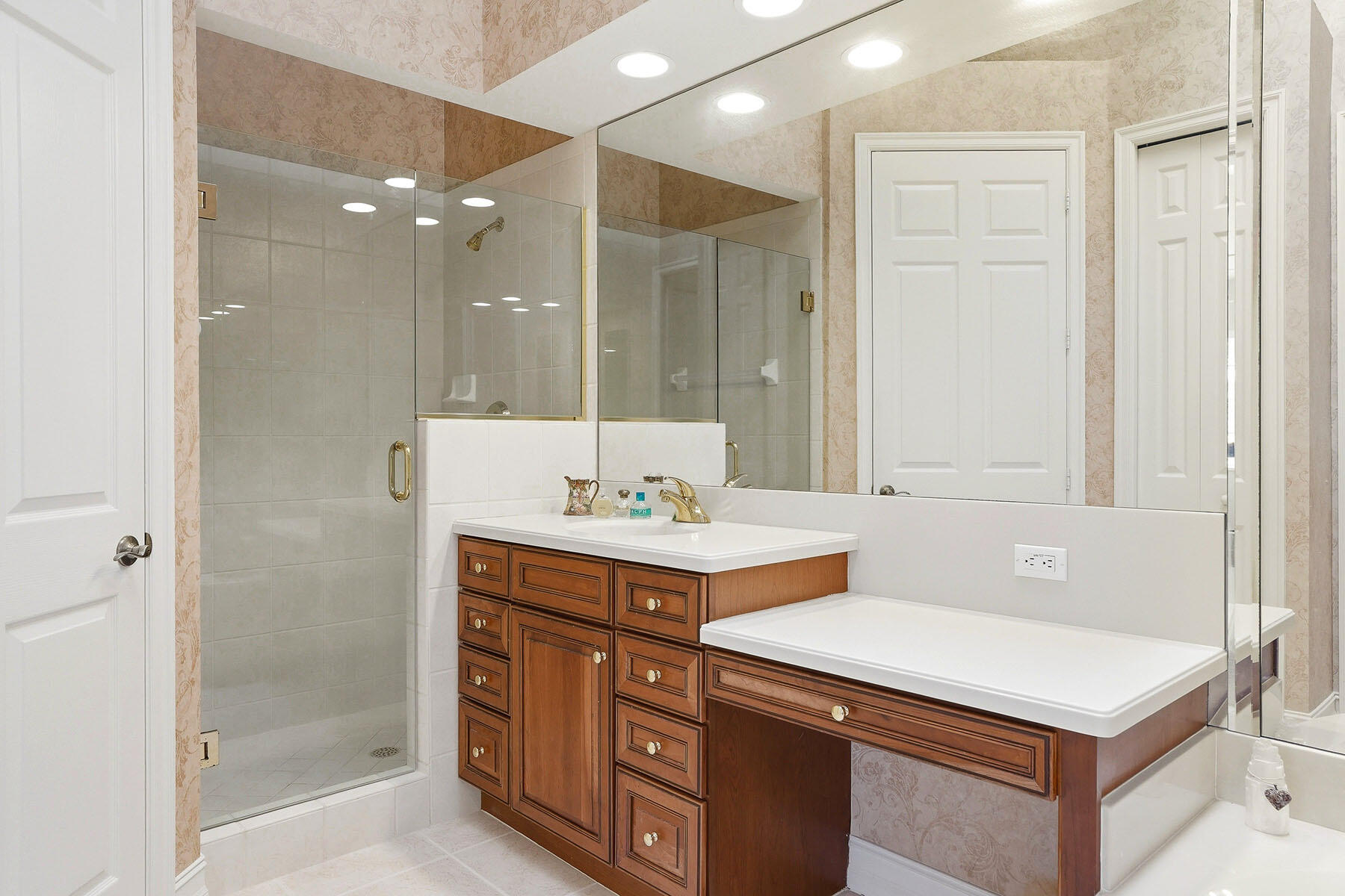 8605 Champions Point, Unit 103 Naples, FL 34113 - Photo 27 of 44 a bathroom with a sink and a mirror