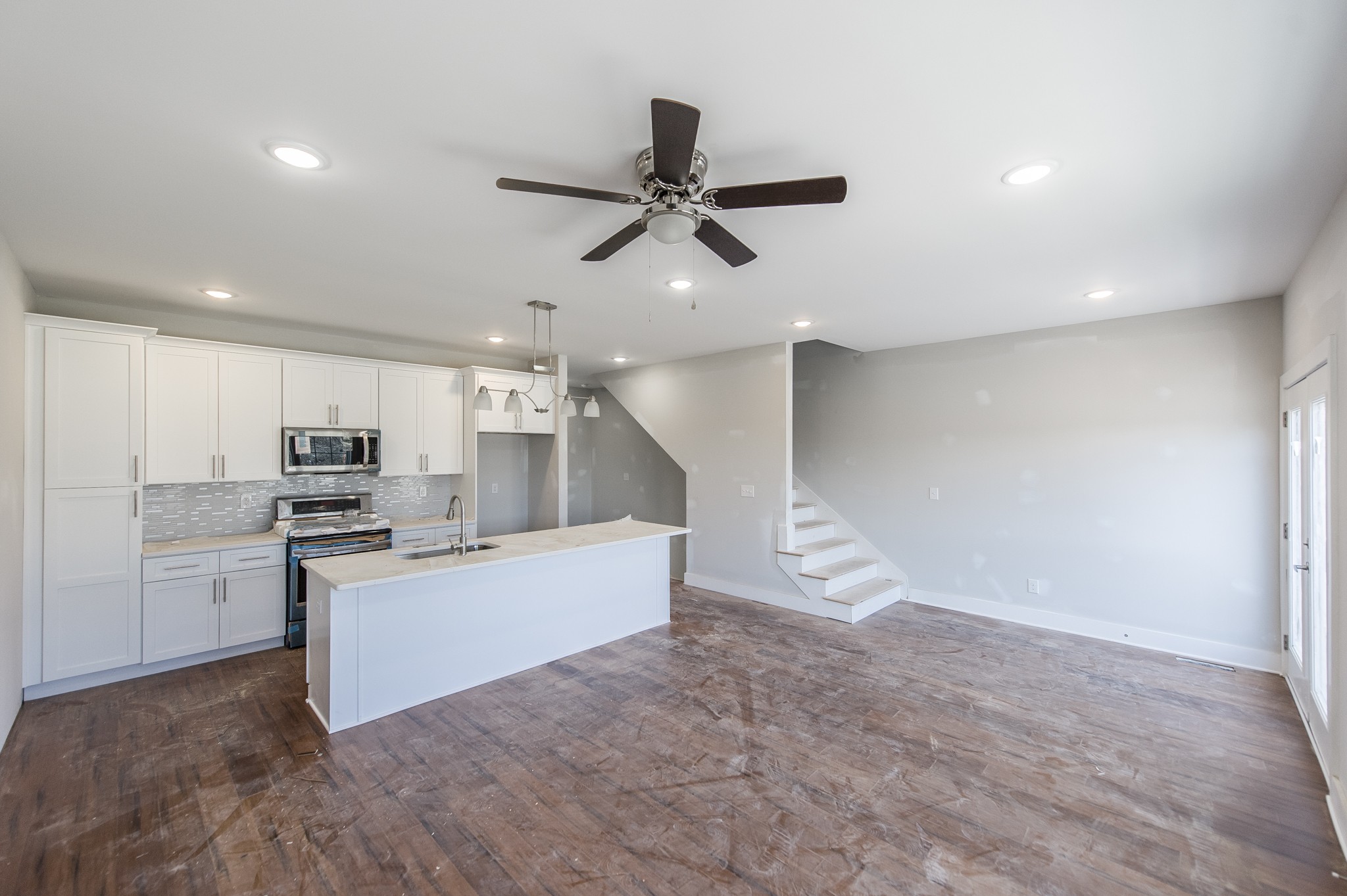 421 Elysian Fields Road, Unit 2 Nashville, TN 37211 - Photo 5 of 22 a kitchen with kitchen island white cabinets and stainless steel appliances