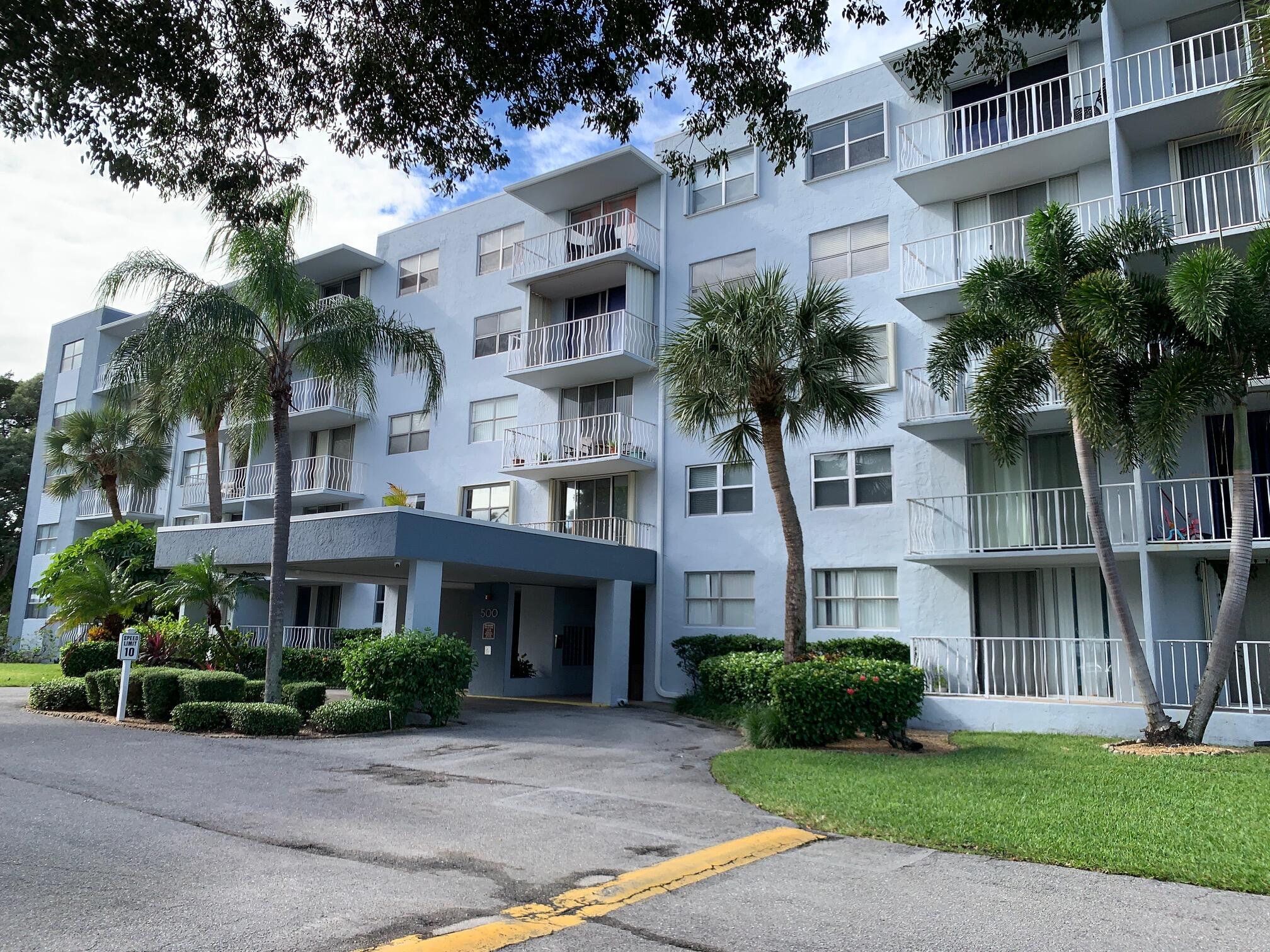 a front view of a residential houses with yard and green space