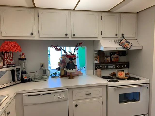 a kitchen with stainless steel appliances granite countertop a sink and cabinets