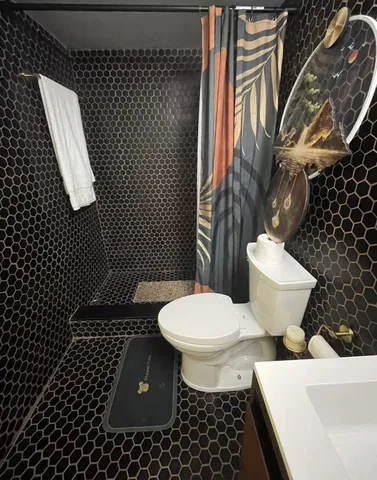 a white toilet sitting on top of a sink