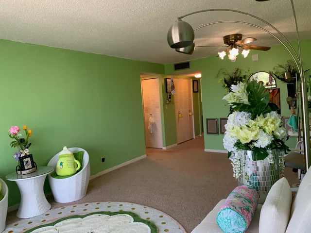 a dining room with furniture and potted plant