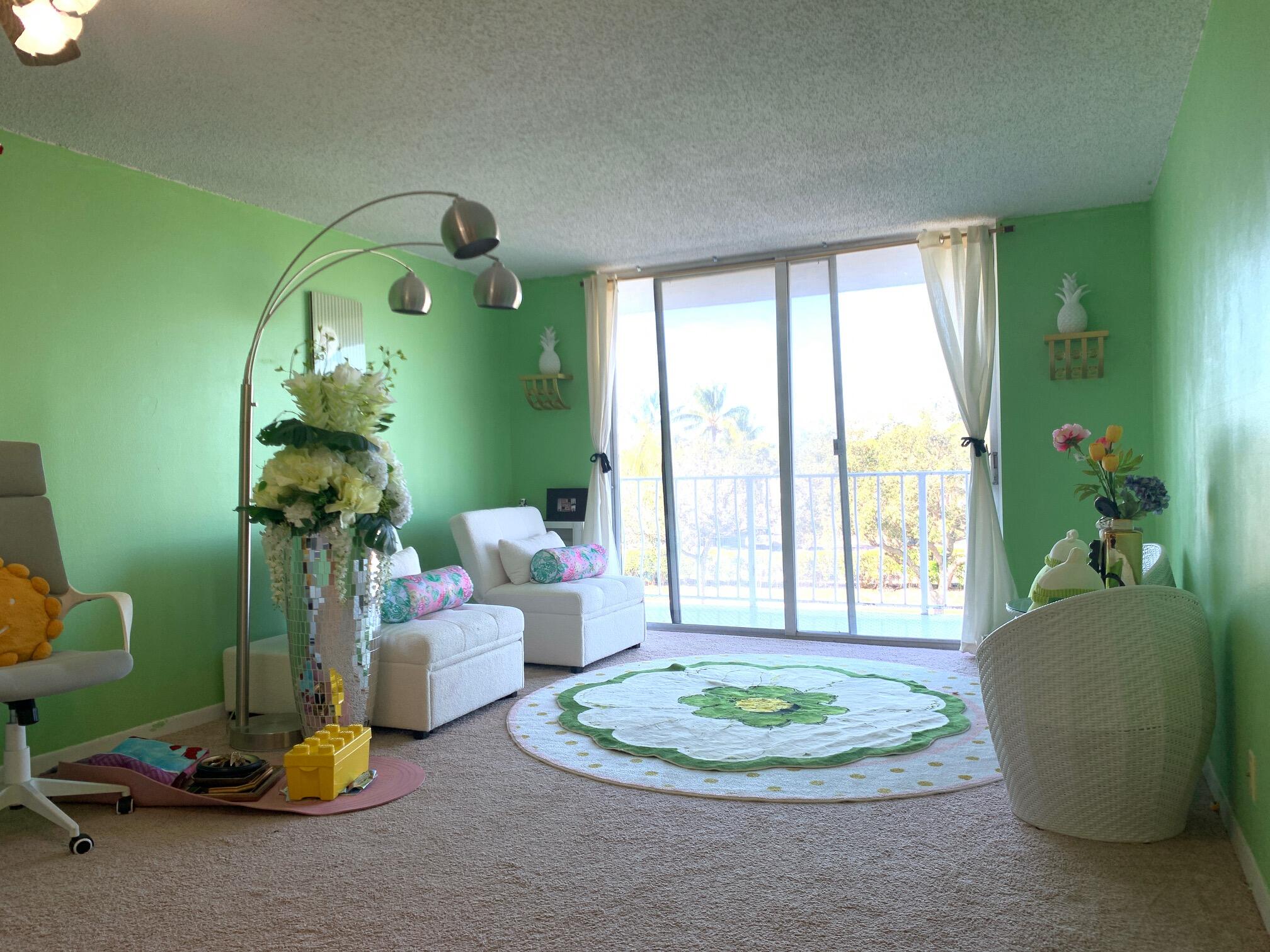 500 Executive Center Drive, Unit 3F West Palm Beach, FL 33401 - Photo 6 of 20 a living room with furniture and a mirror