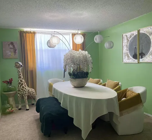 a dining room with furniture and wooden floor