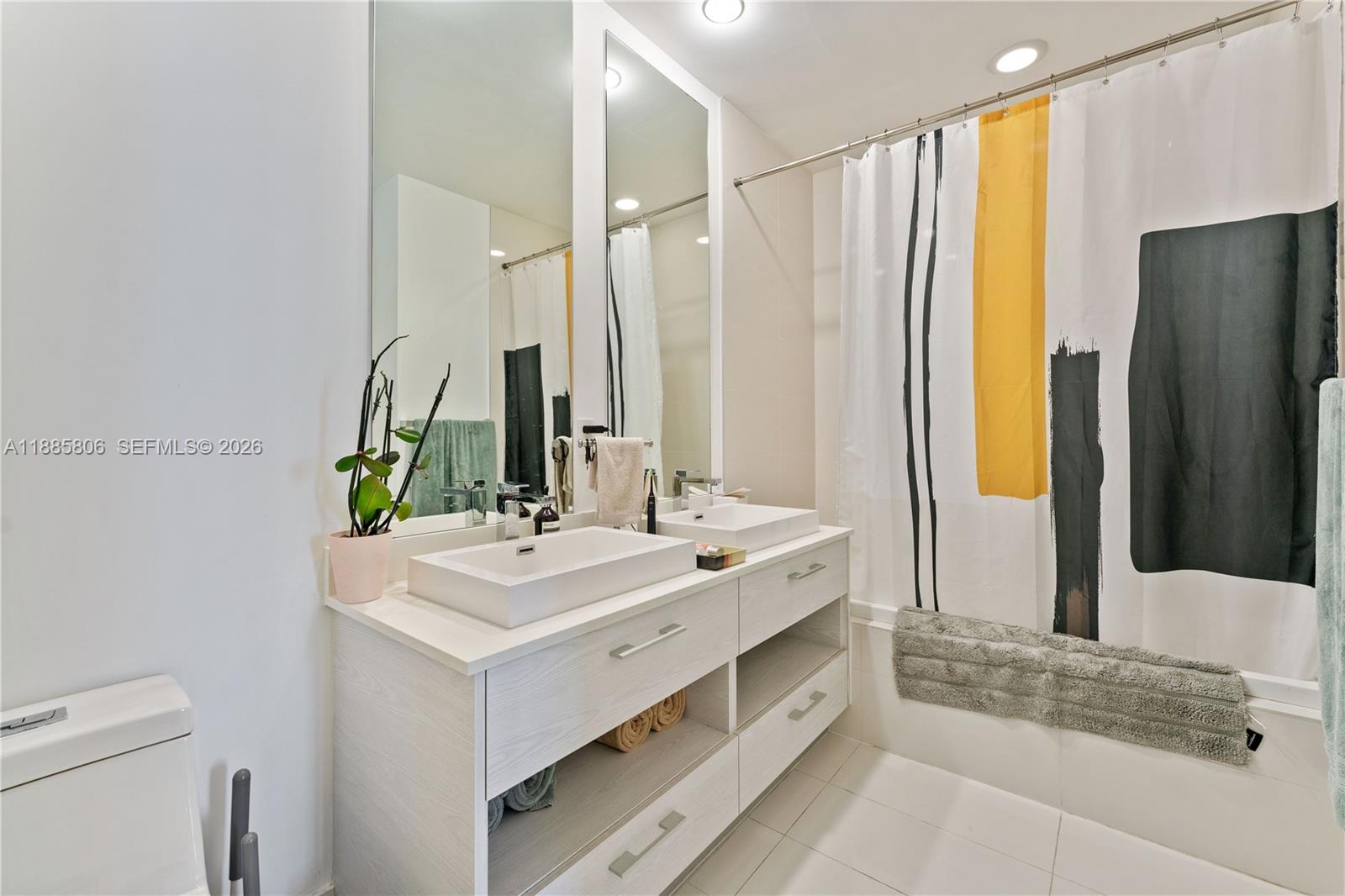 45 Southwest 9th Street, Unit 4205 Miami, FL 33130 - Photo 20 of 32 a bathroom with a double vanity sink and a mirror