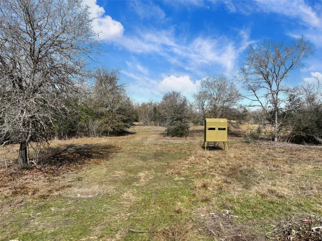 a backyard of a house with a table and chairs