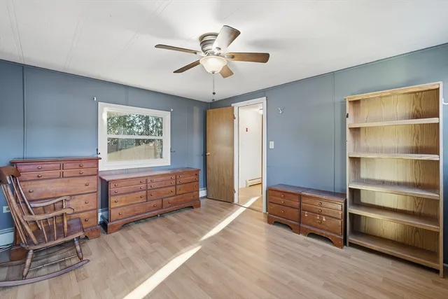 a view of a livingroom with furniture and a ceiling fan