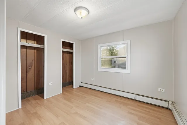 an empty room with windows and closet