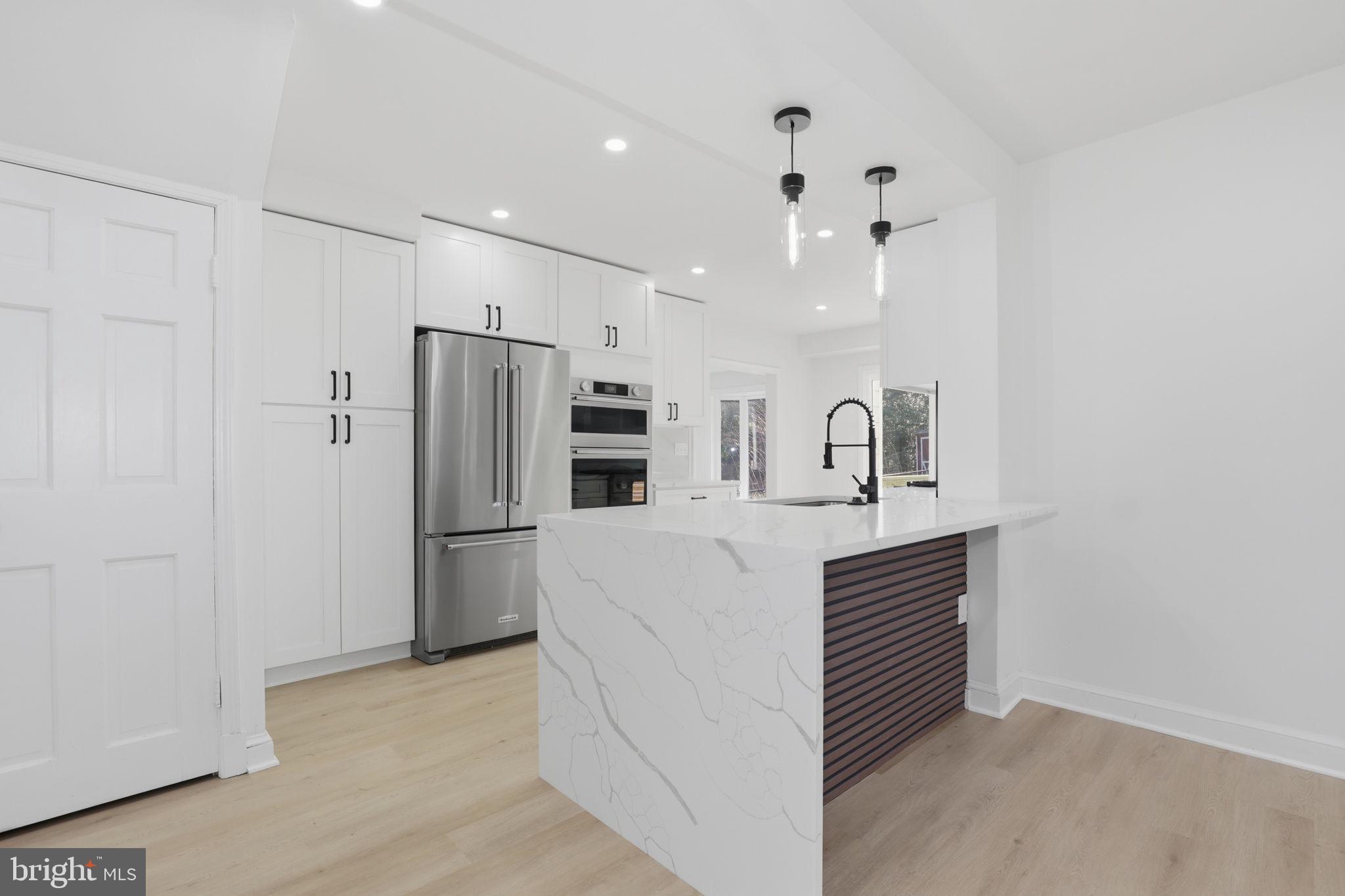 311 Ellsworth Drive Silver Spring, MD 20910 - Photo 12 of 60 a kitchen with refrigerator cabinets and a sink
