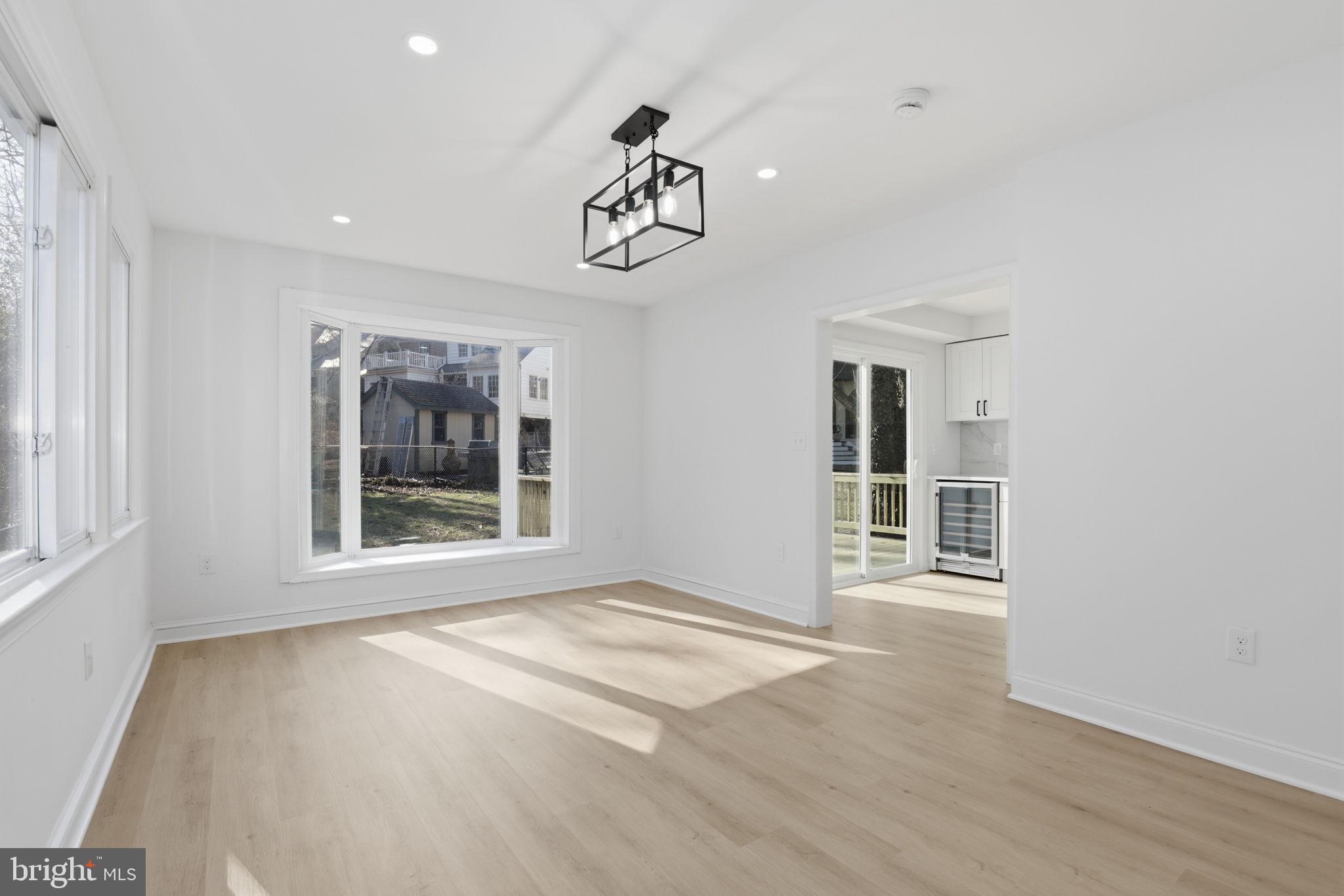 311 Ellsworth Drive Silver Spring, MD 20910 - Photo 20 of 60 a view of an empty room with a window and wooden floor