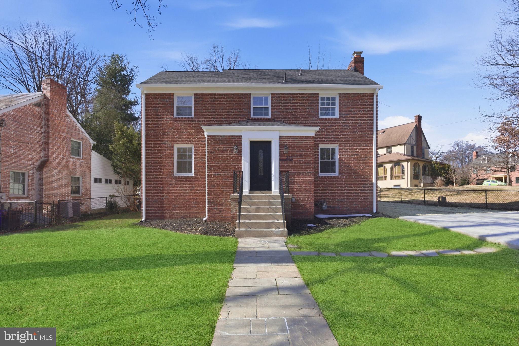 311 Ellsworth Drive Silver Spring, MD 20910 - Photo 2 of 60 a front view of a house with a yard