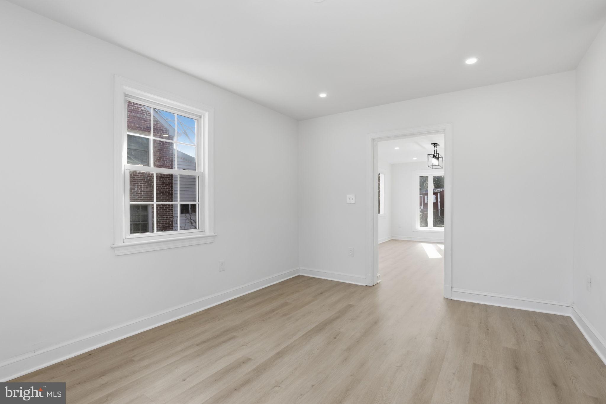 311 Ellsworth Drive Silver Spring, MD 20910 - Photo 24 of 60 an empty room with wooden floor and windows