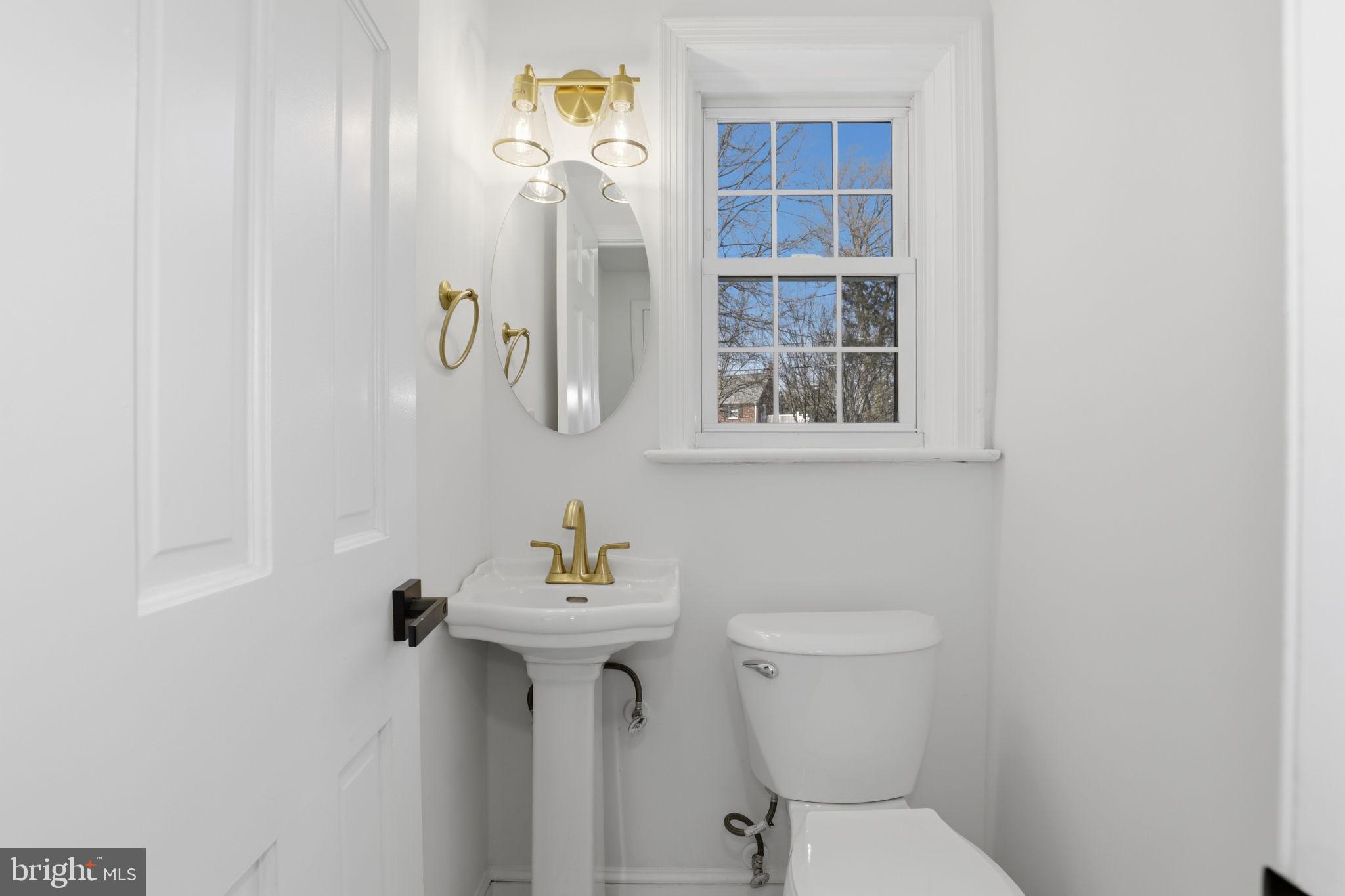 311 Ellsworth Drive Silver Spring, MD 20910 - Photo 25 of 60 a bathroom with a sink toilet and mirror