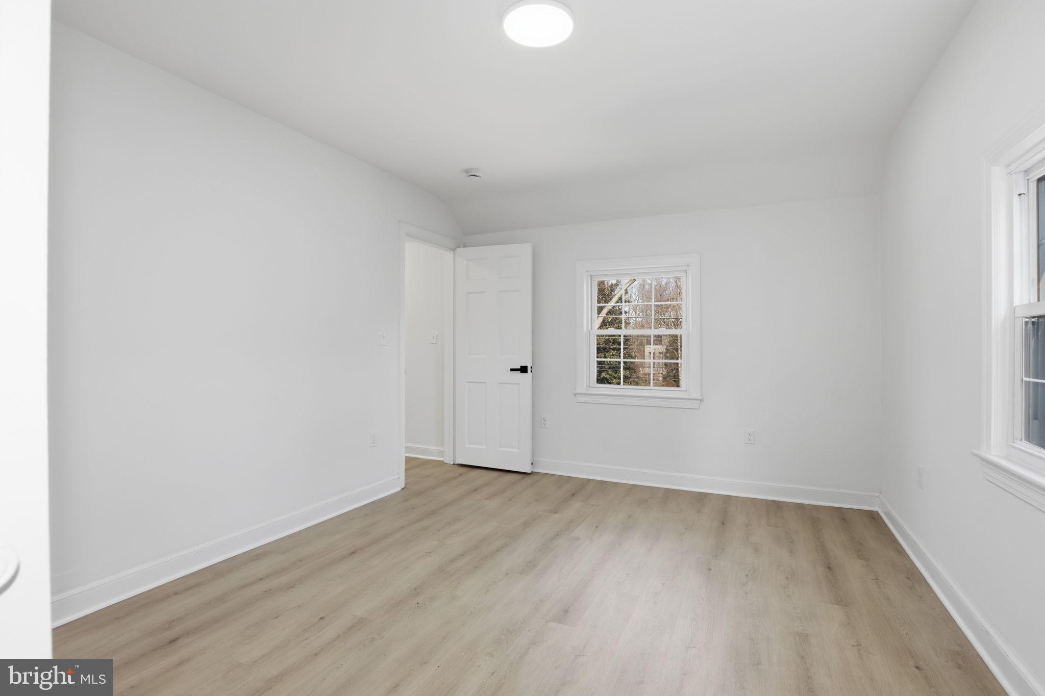 311 Ellsworth Drive Silver Spring, MD 20910 - Photo 40 of 60 an empty room with wooden floor and windows