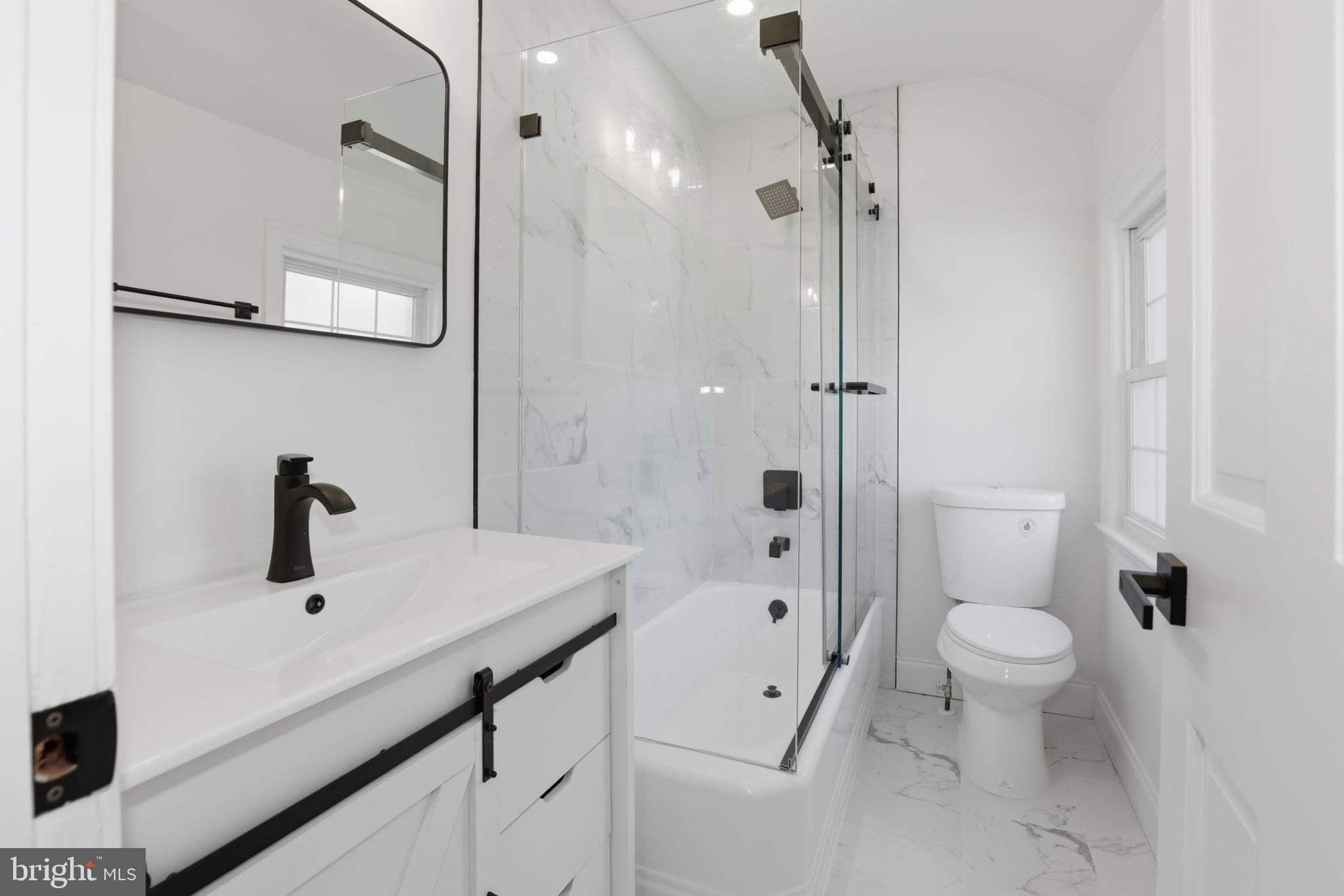 311 Ellsworth Drive Silver Spring, MD 20910 - Photo 41 of 60 a bathroom with a sink a toilet and shower