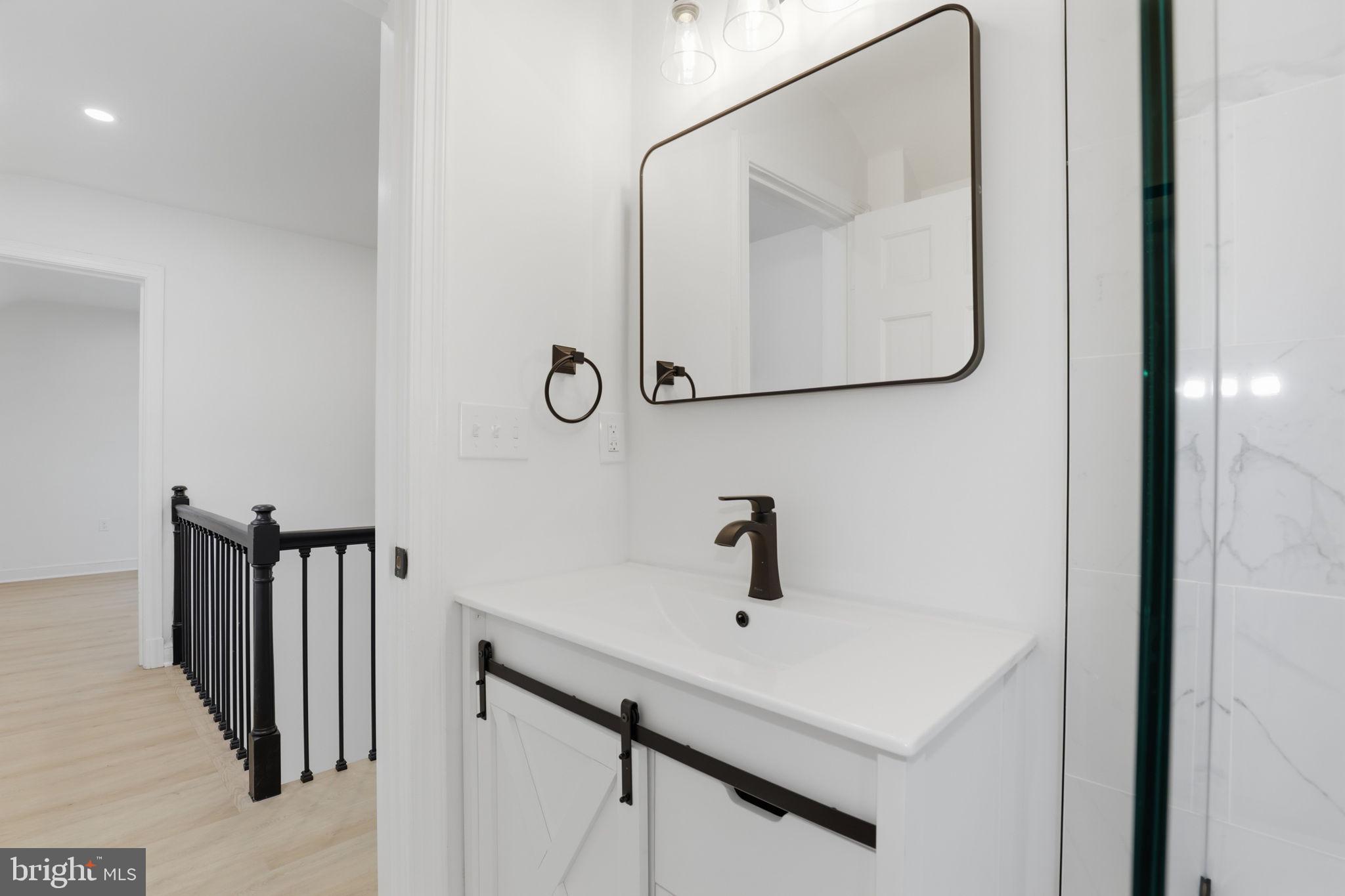 311 Ellsworth Drive Silver Spring, MD 20910 - Photo 42 of 60 a bathroom with a sink and mirror