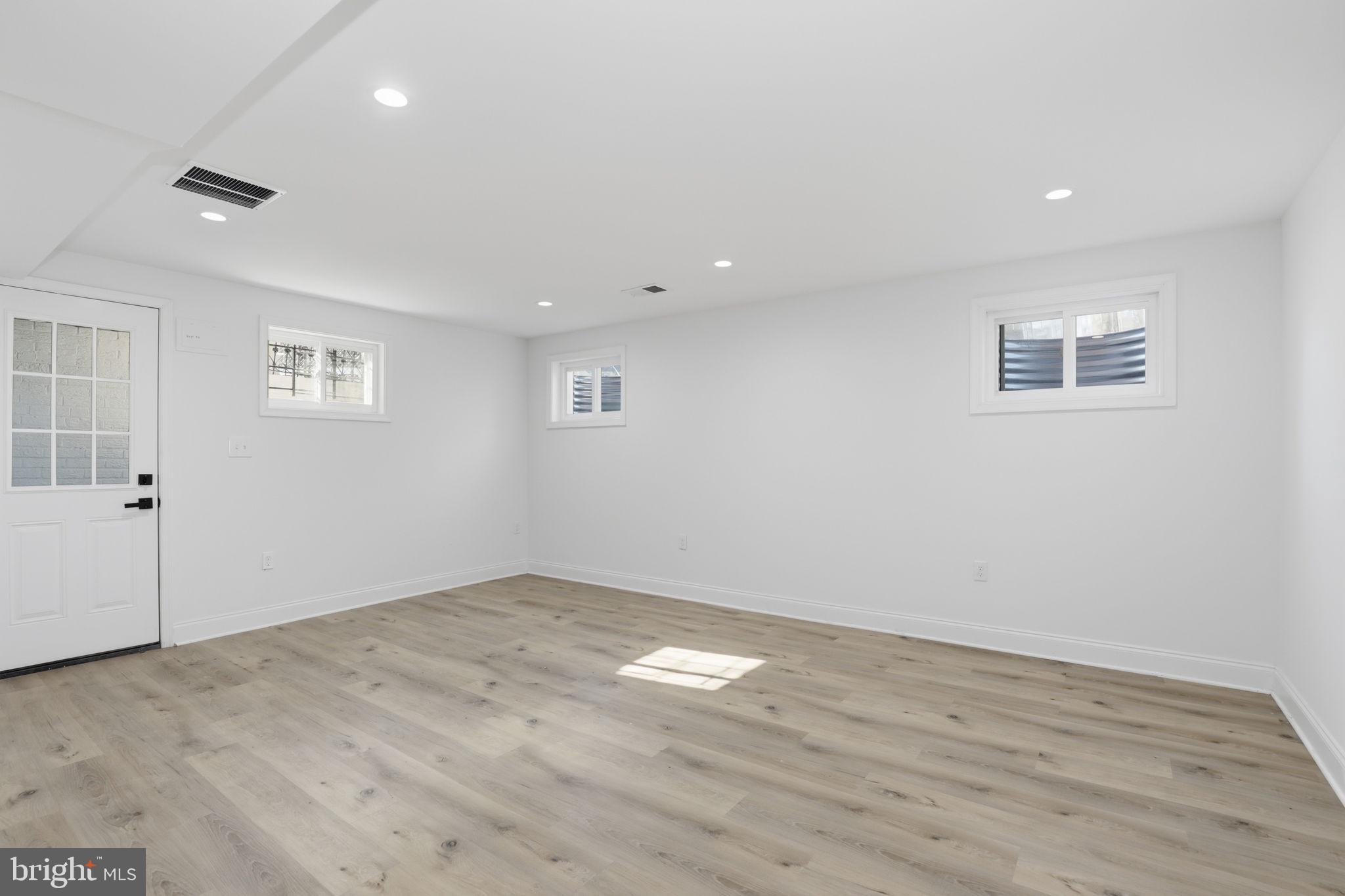 311 Ellsworth Drive Silver Spring, MD 20910 - Photo 44 of 60 an empty room with wooden floor and windows