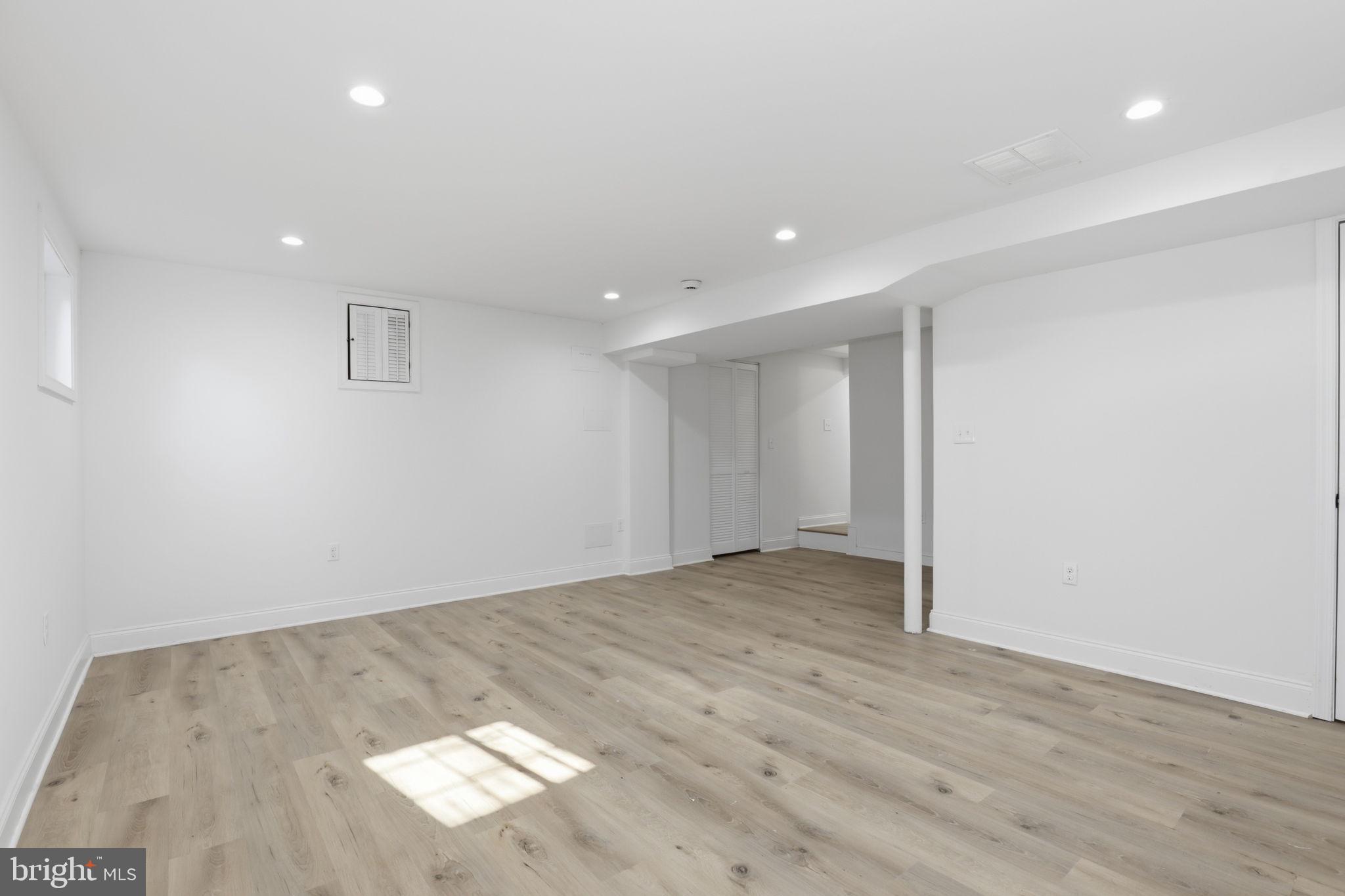 311 Ellsworth Drive Silver Spring, MD 20910 - Photo 47 of 60 an empty room with wooden floor and natural light