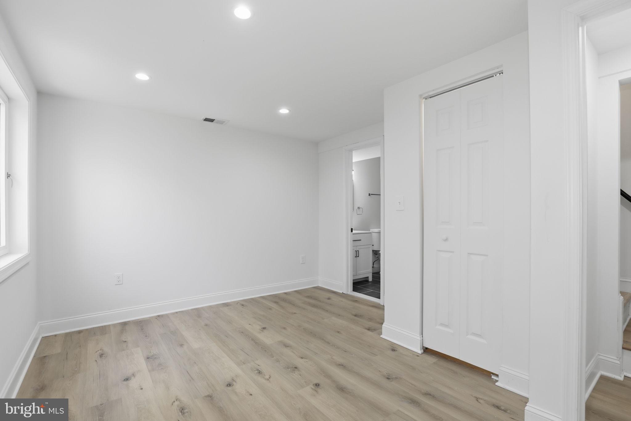 311 Ellsworth Drive Silver Spring, MD 20910 - Photo 49 of 60 an empty room with wooden floor and windows