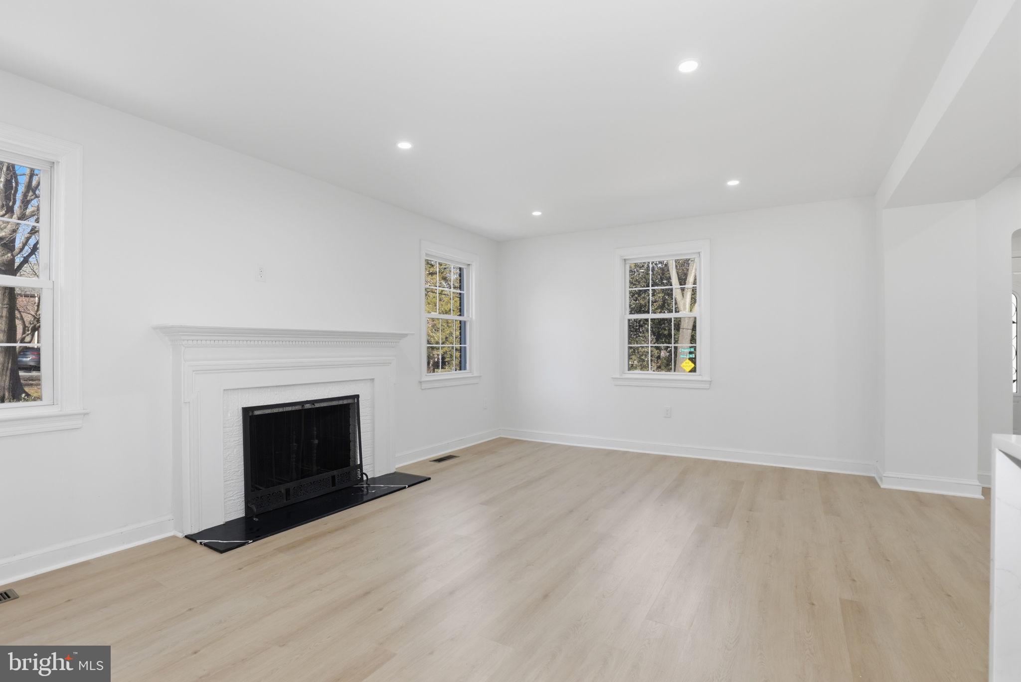311 Ellsworth Drive Silver Spring, MD 20910 - Photo 10 of 60 an empty room with windows and fireplace