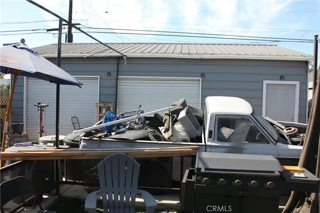 a view of a patio with table and chairs