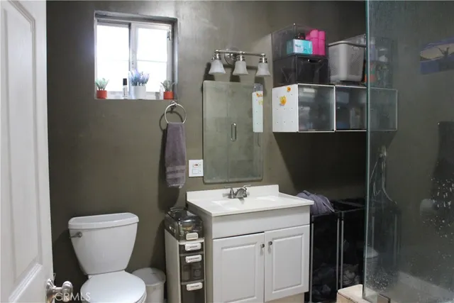 a bathroom with a toilet sink and mirror
