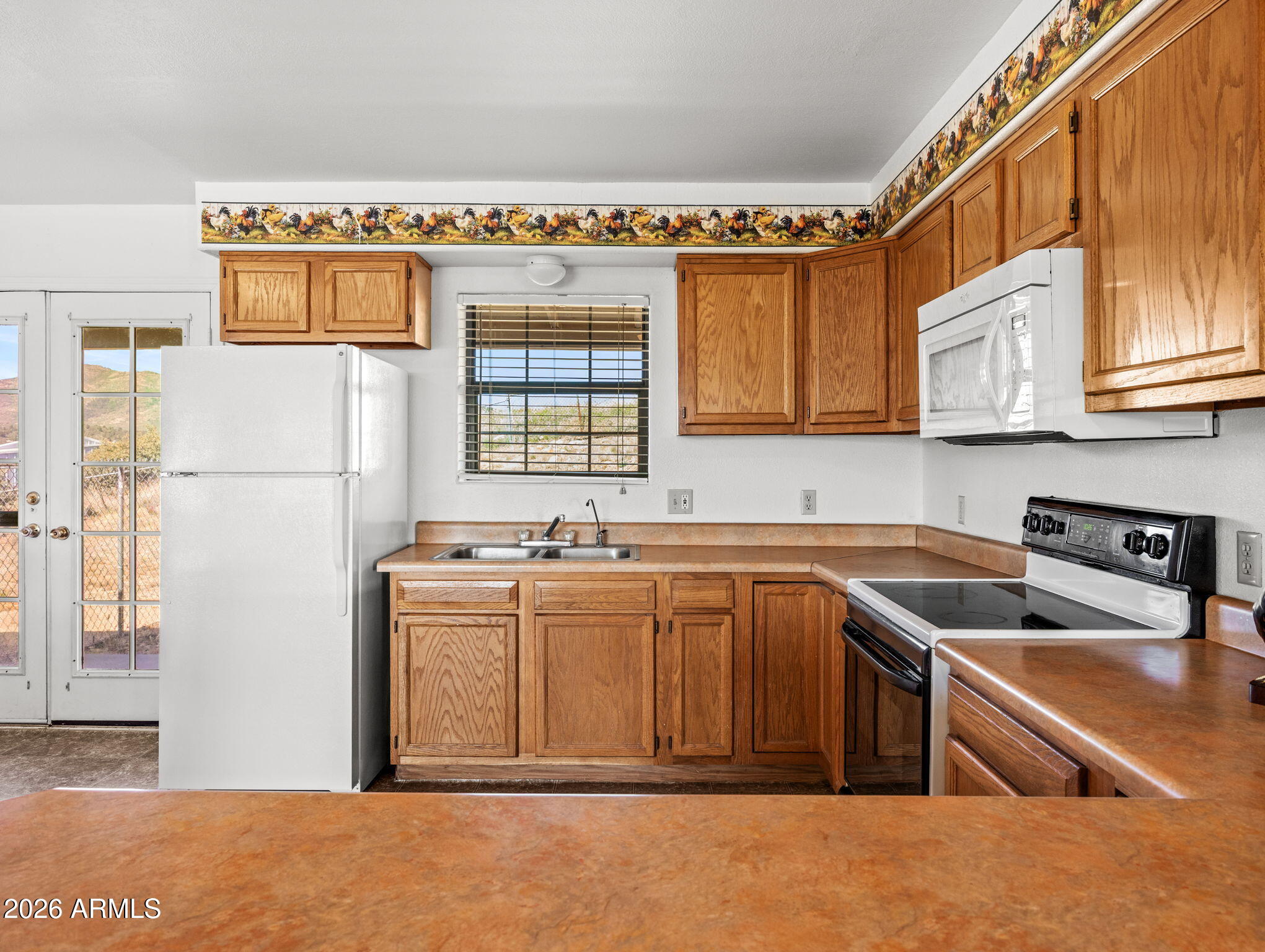 18420 Peeples Valley Road Peeples Valley, AZ 86332 - Photo 14 of 31 a kitchen that has a sink and a stove