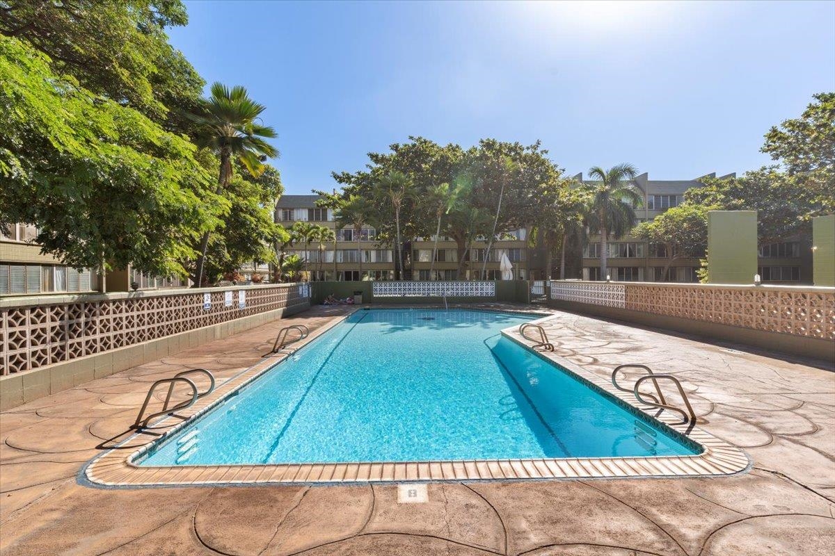 111 Kahului Beach Road, Unit D117 Kahului, HI 96732 - Photo 4 of 8 a view of swimming pool with outdoor seating and trees in the background