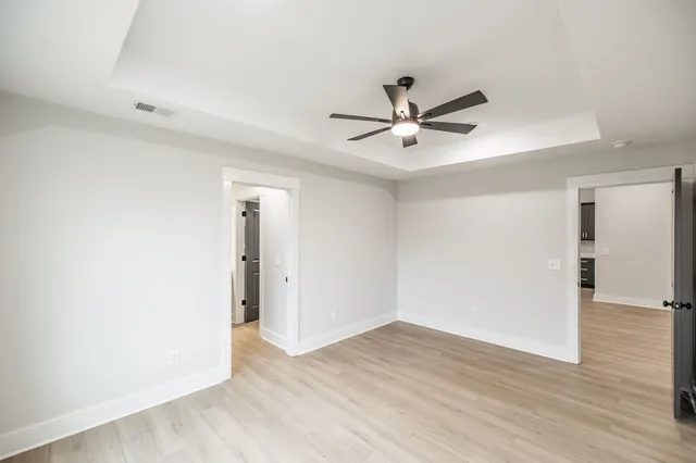 a view of an empty room with wooden floor