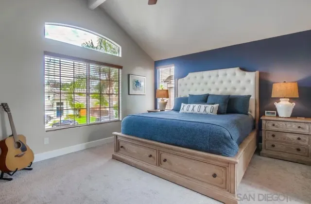 a spacious bedroom with a bed and a window