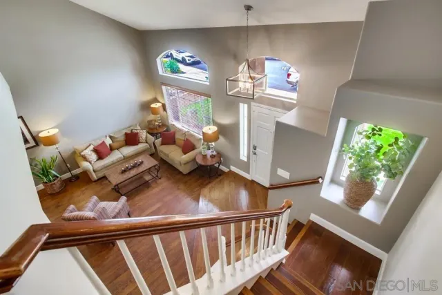 a view of a livingroom with furniture wooden floor and front door