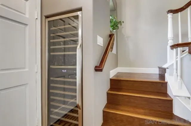 a view of staircase with white walls and railing