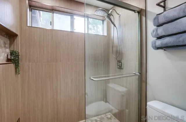 a bathroom with a glass shower door
