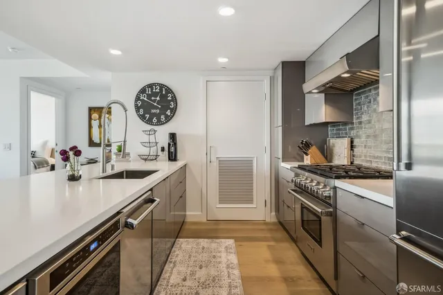 a kitchen with a sink and a stove top oven