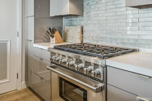 a spacious bedroom with a bed a table and large window