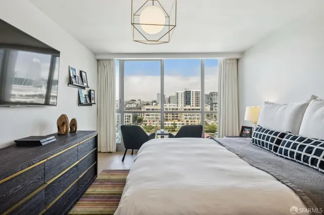 a view of a room with furniture and large windows