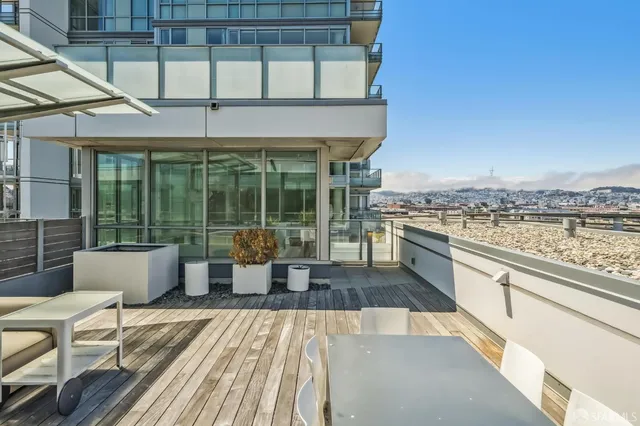 a kitchen with granite countertop a sink and white cabinets