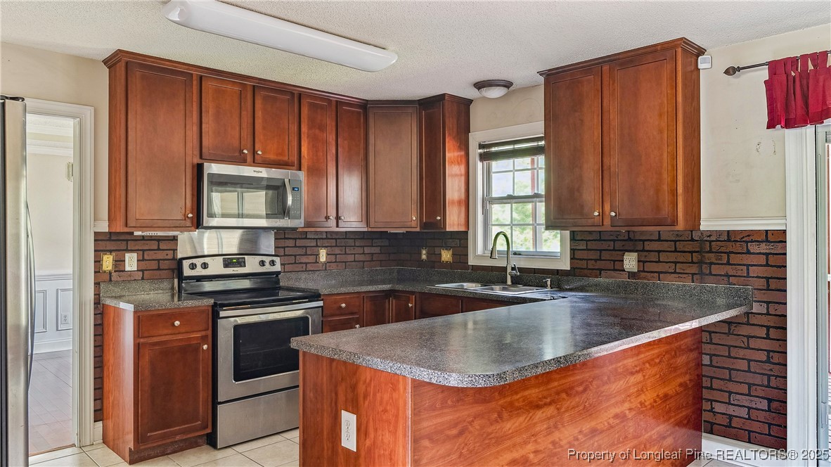 106 Linden Road Cameron, NC 28326 - Photo 13 of 48 a kitchen with stainless steel appliances granite countertop a sink stove and cabinets