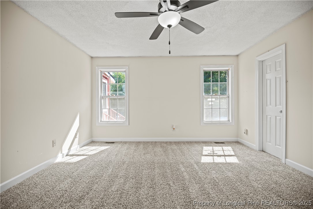 106 Linden Road Cameron, NC 28326 - Photo 17 of 48 an empty room with windows and fan