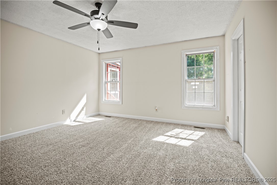 106 Linden Road Cameron, NC 28326 - Photo 18 of 48 a view of empty room with window and ceiling fan