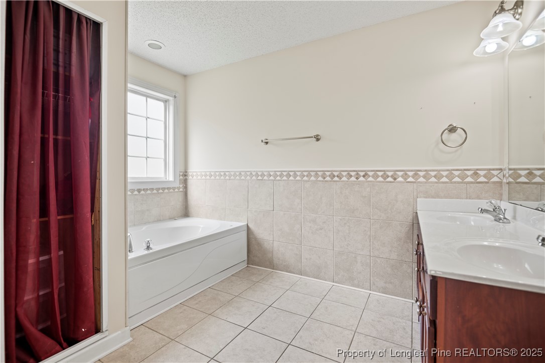 106 Linden Road Cameron, NC 28326 - Photo 19 of 48 a bathroom with a bathtub a sink and a window
