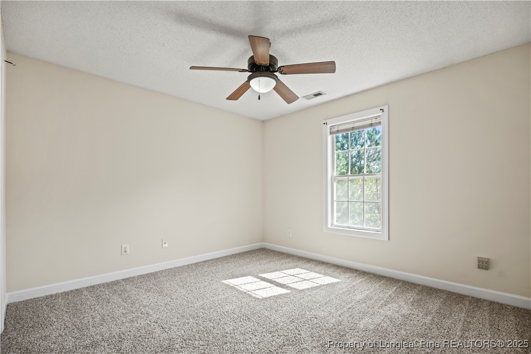 106 Linden Road Cameron, NC 28326 - Photo 27 of 48 an empty room with a window and a fan