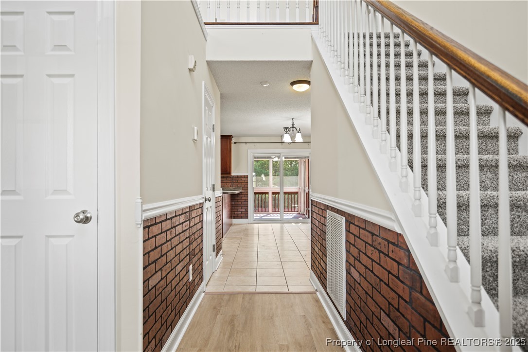 106 Linden Road Cameron, NC 28326 - Photo 3 of 48 a view of a hallway with wooden floor and staircase