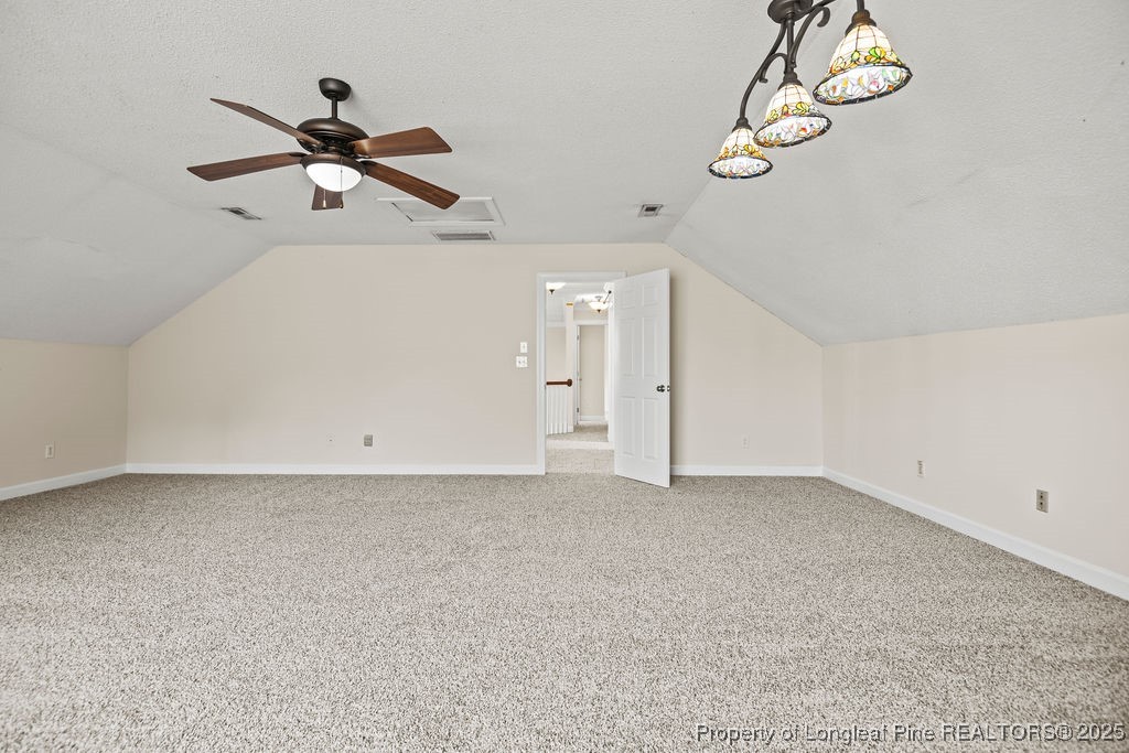 106 Linden Road Cameron, NC 28326 - Photo 34 of 48 an empty room with a chandelier fan and wooden floor